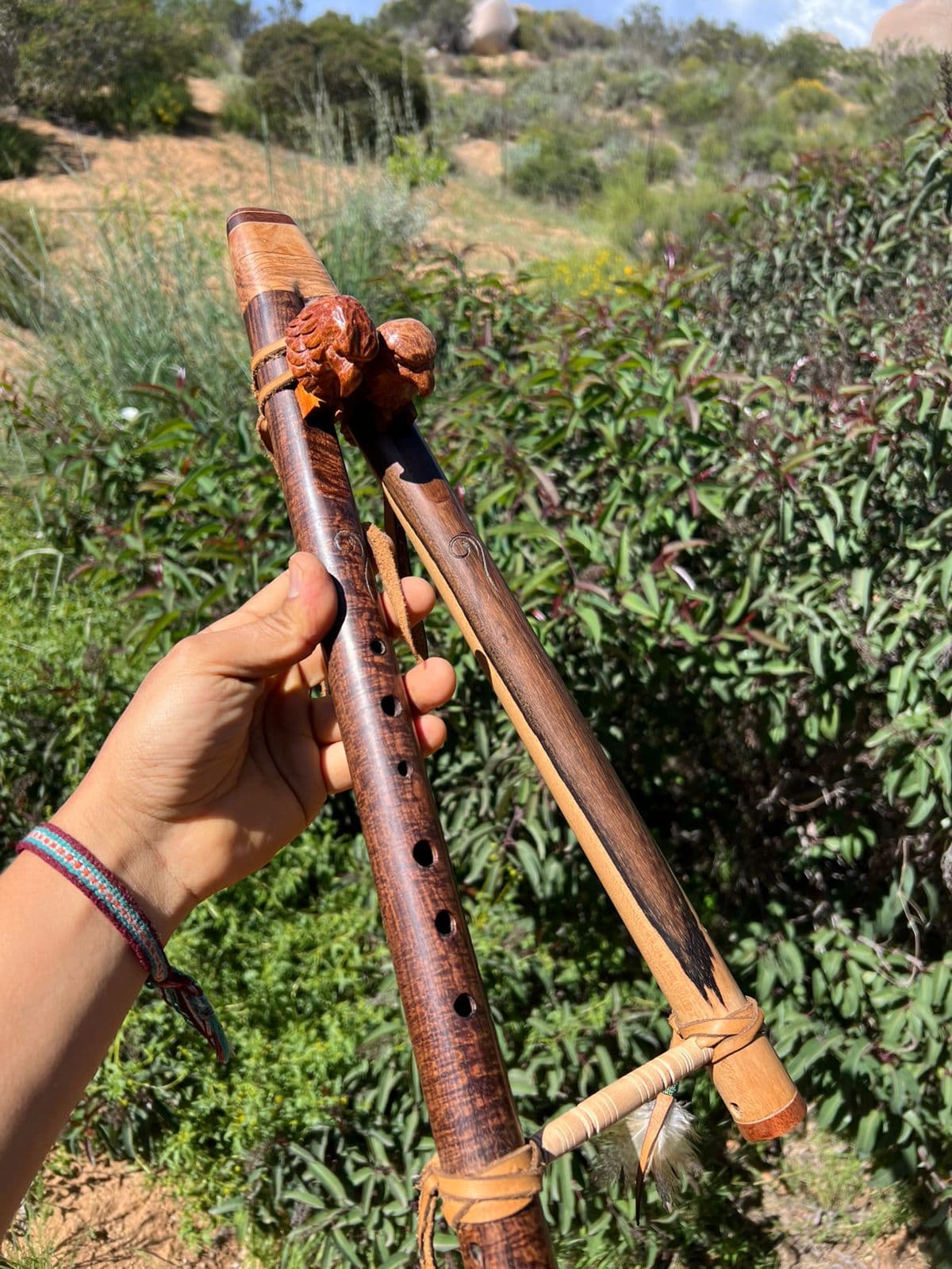 Mauricio Naranjo holding a finished flute outdoors